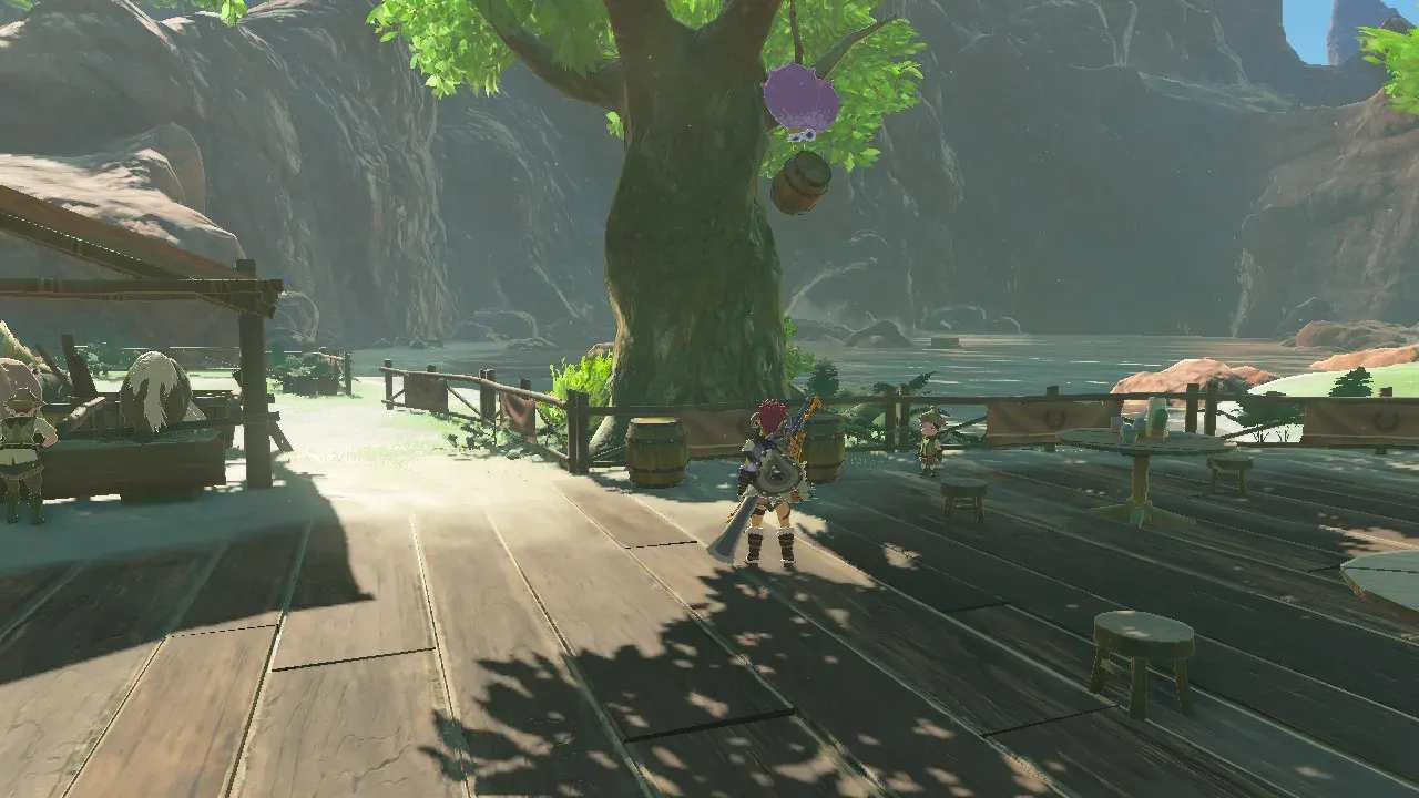 A wooden barrel hanging in the air under a purple Octo Balloon beside a tree, with Link standing on a wooden deck below