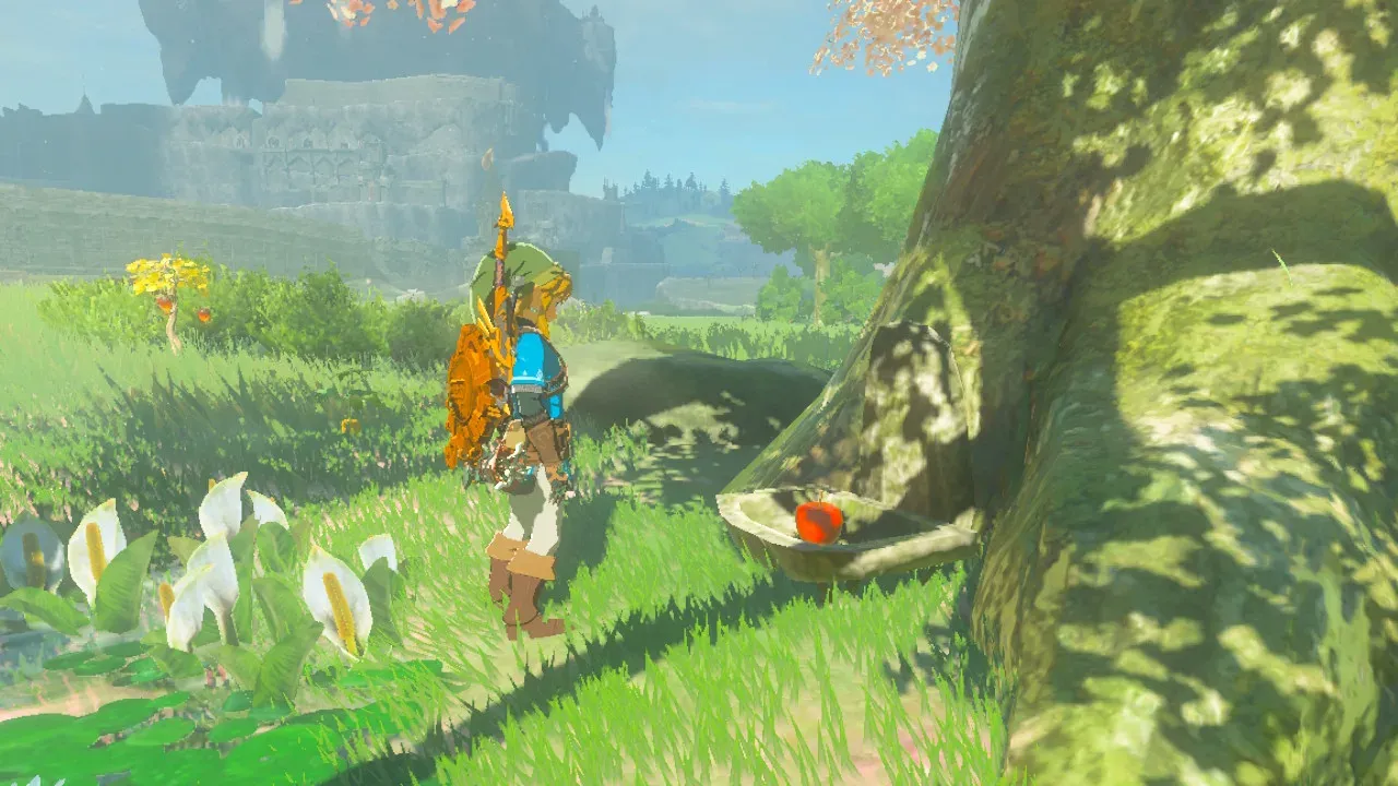 Link standing at the foot of a cherry-blossom tree with an apple in the stone dish