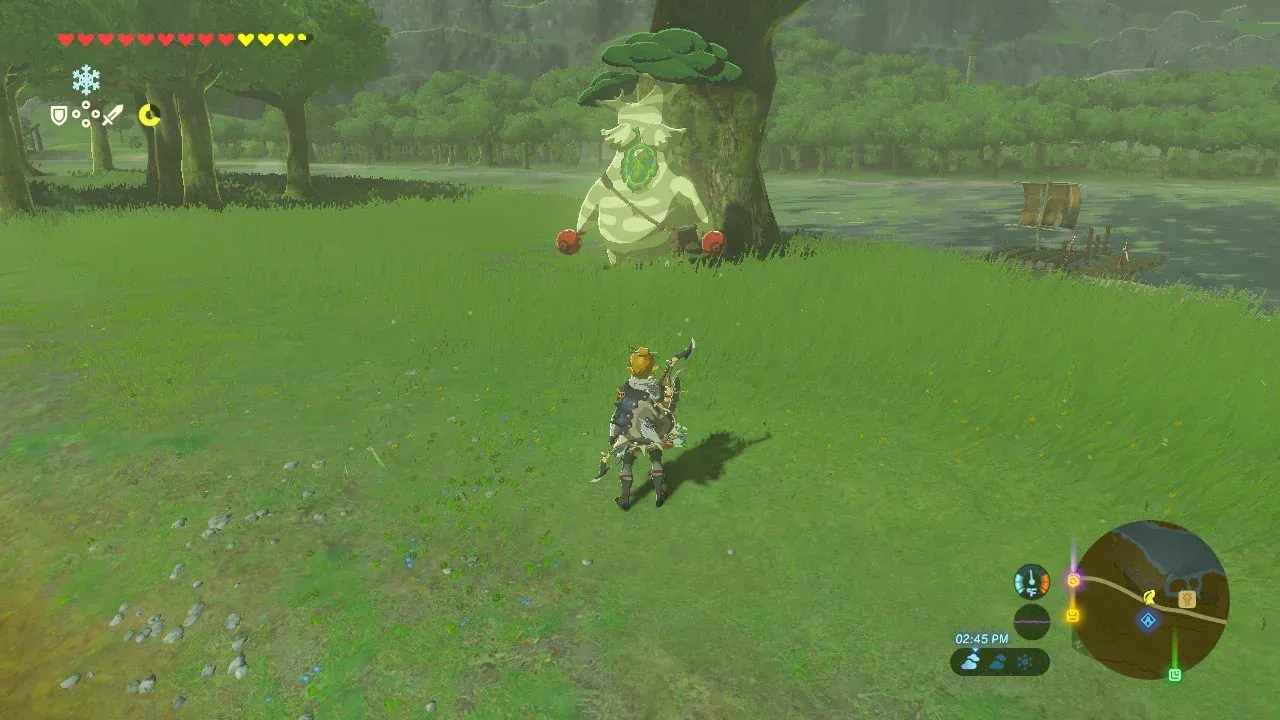Hestu standing under a large tree near Riverside Stable as Link walks up