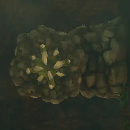 A Rock Like on a dark cave wall, a mass of grey boulders around a green mouth with white teeth