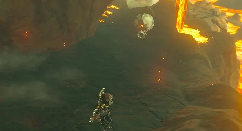 A Rock Octorok with a boulder on its head poking out of a dark volcanic slope near lava, with Link below