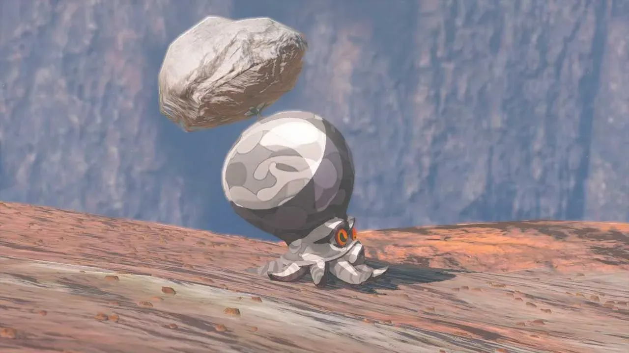 A grey Rock Octorok on reddish volcanic ground holding a boulder over its head