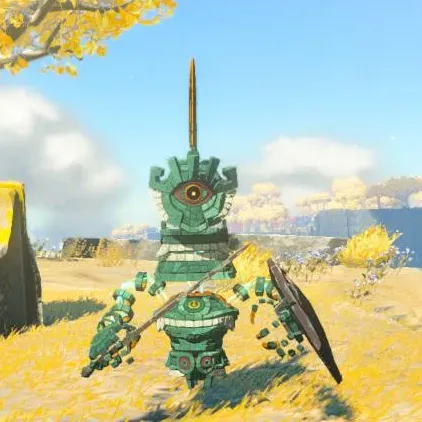 A green Soldier Construct I with one eye, a thin spike on its head, a stick and a wooden shield on a grassy plain