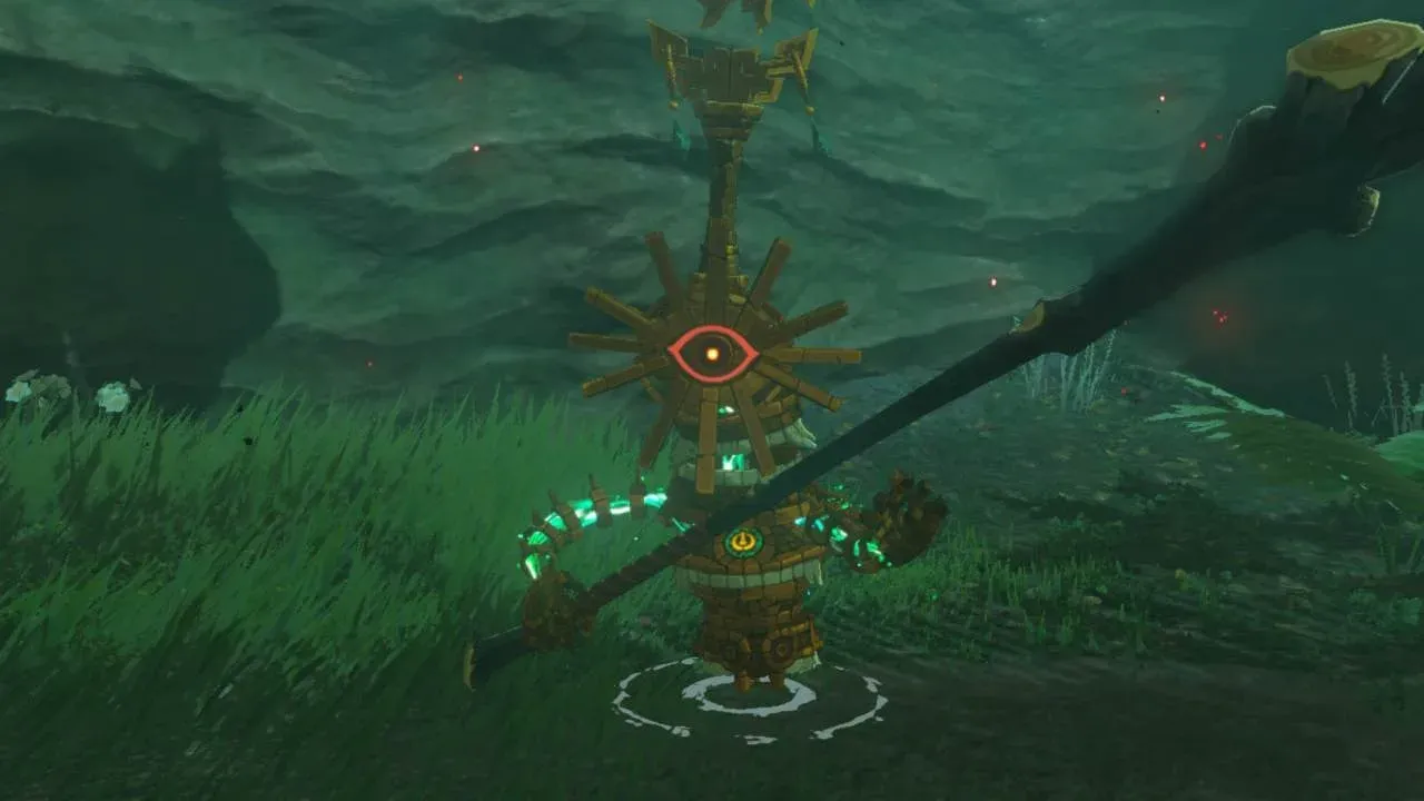 A golden Soldier Construct IV with a sunburst ornament around its eye and a disk on its head, swinging a thick stick