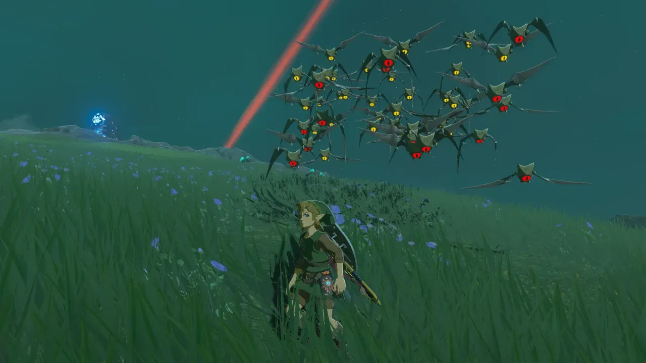 Link standing in tall grass at night while a large swarm of one-eyed Keese flies overhead