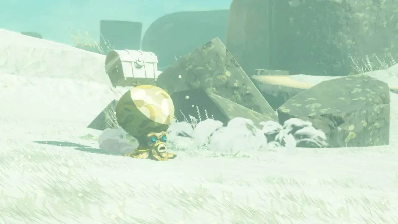 A yellow Treasure Octorok bursting out of the snow with a treasure chest above its head