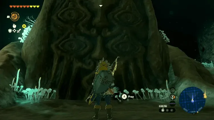 Link in front of the giant Bargainer Statue at the Wellspring of Wisdom, with the Pray prompt